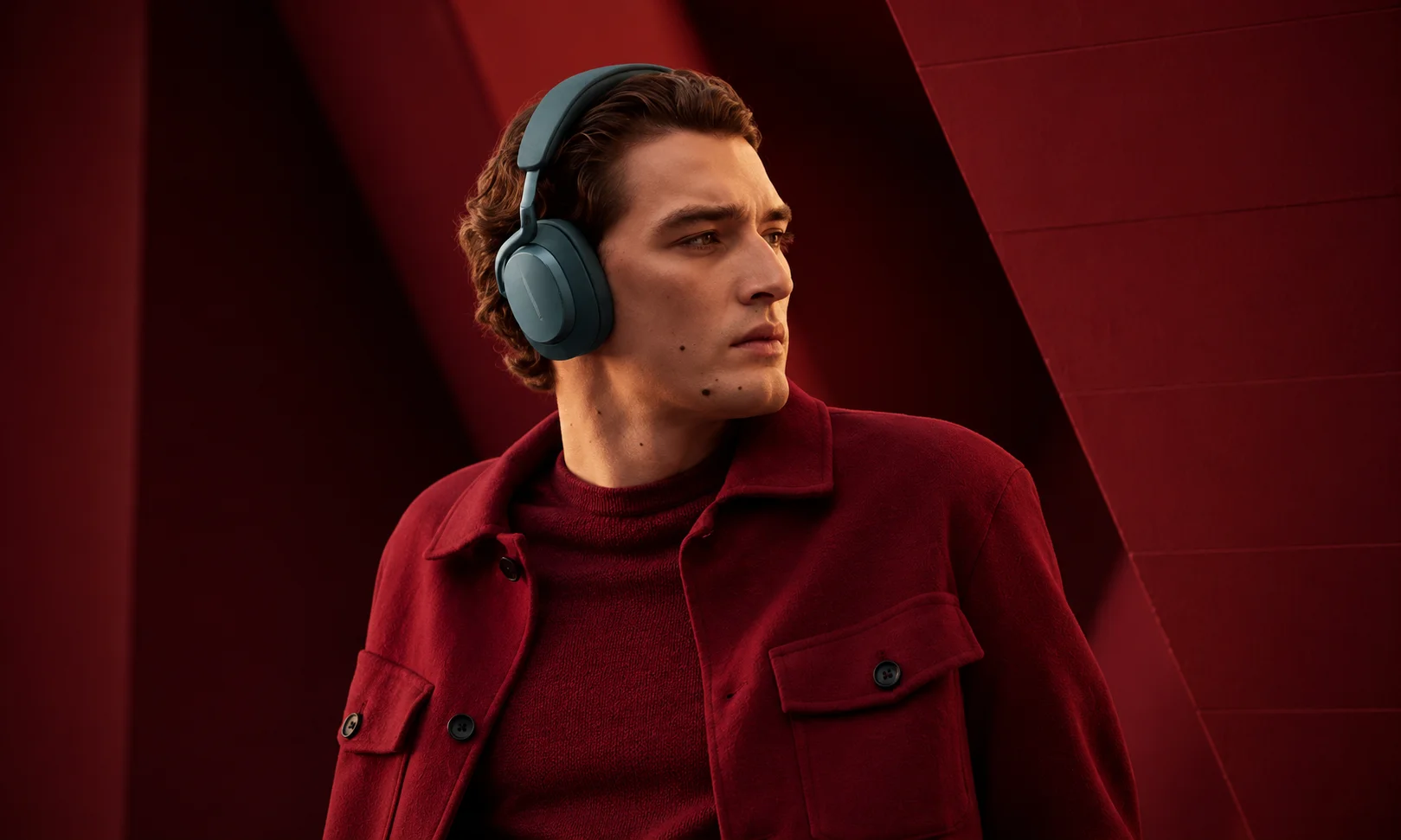 A person wearing Bowers & Wilkins Px7 S3 headphones.