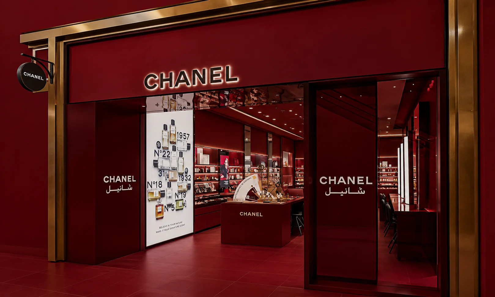 A luxury Chanel retail display showcased under a warm red-toned aesthetic.