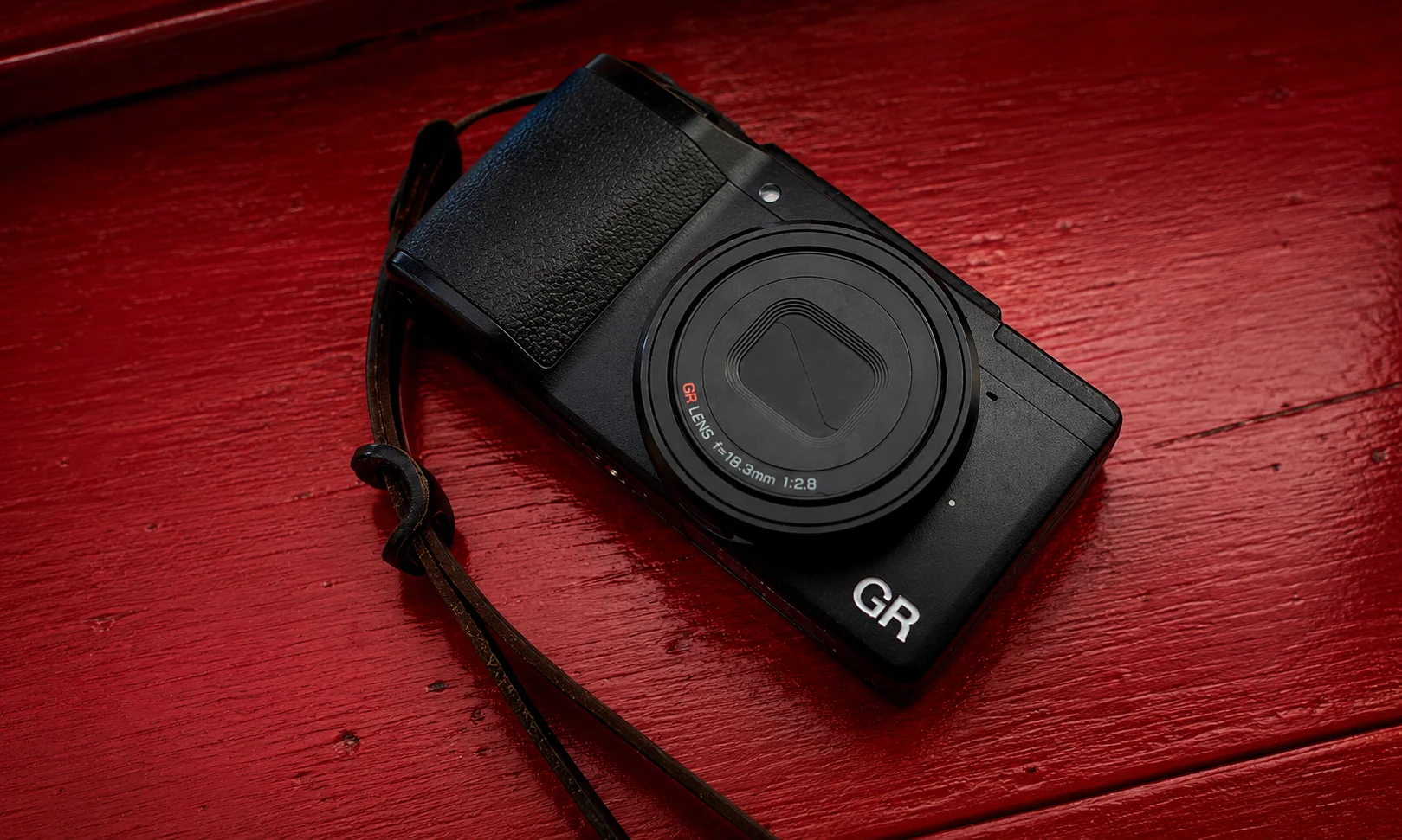 Ricoh GR IIIx compact camera body held in hand showing its lightweight and portable design for daily carry.