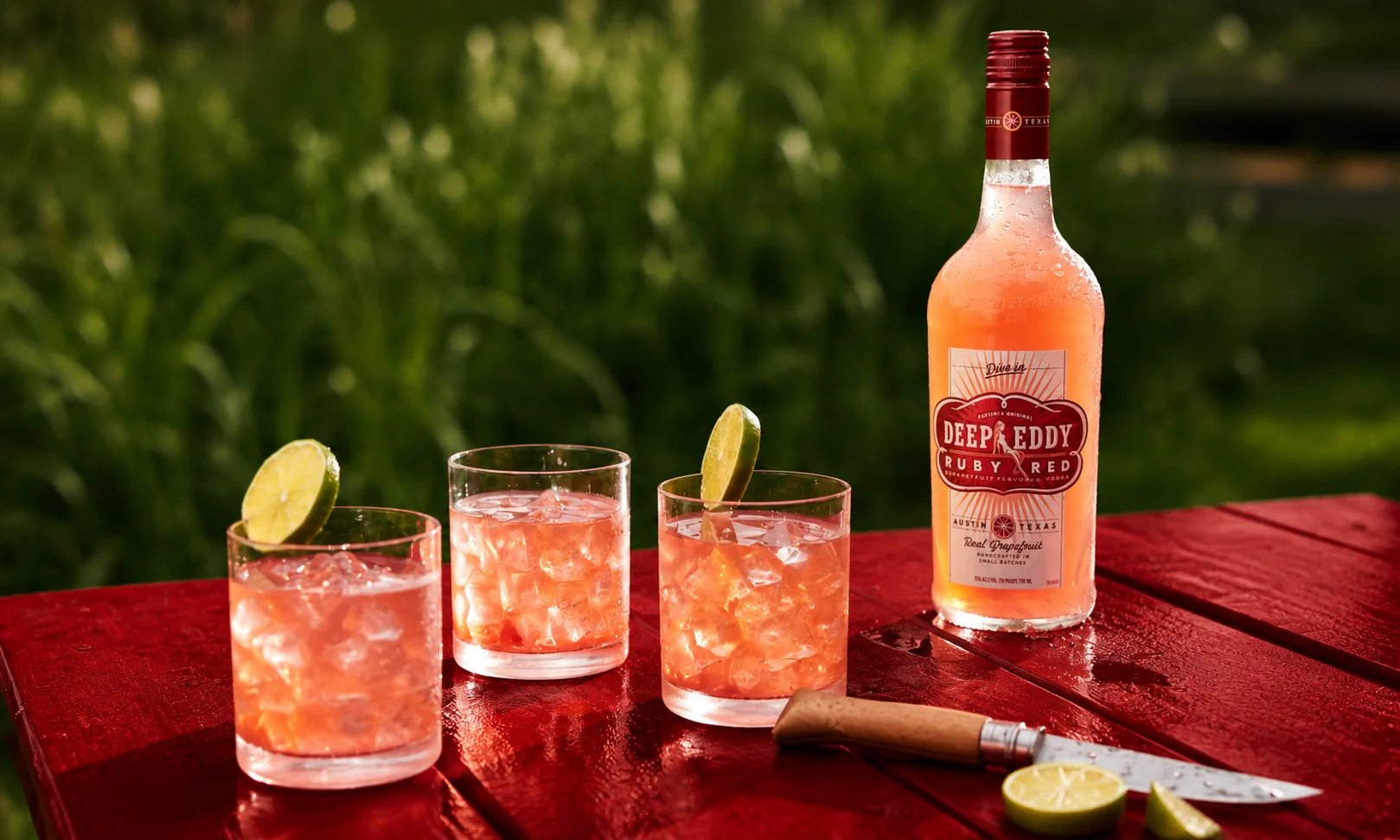 Bottle of Deep Eddy Ruby Red Flavored Vodka blended with real grapefruit juice.