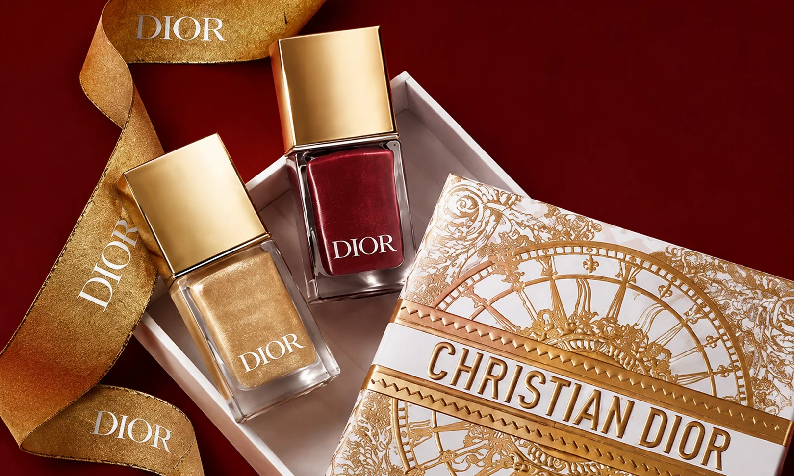 Dior perfume bottles arranged against a deep red background.