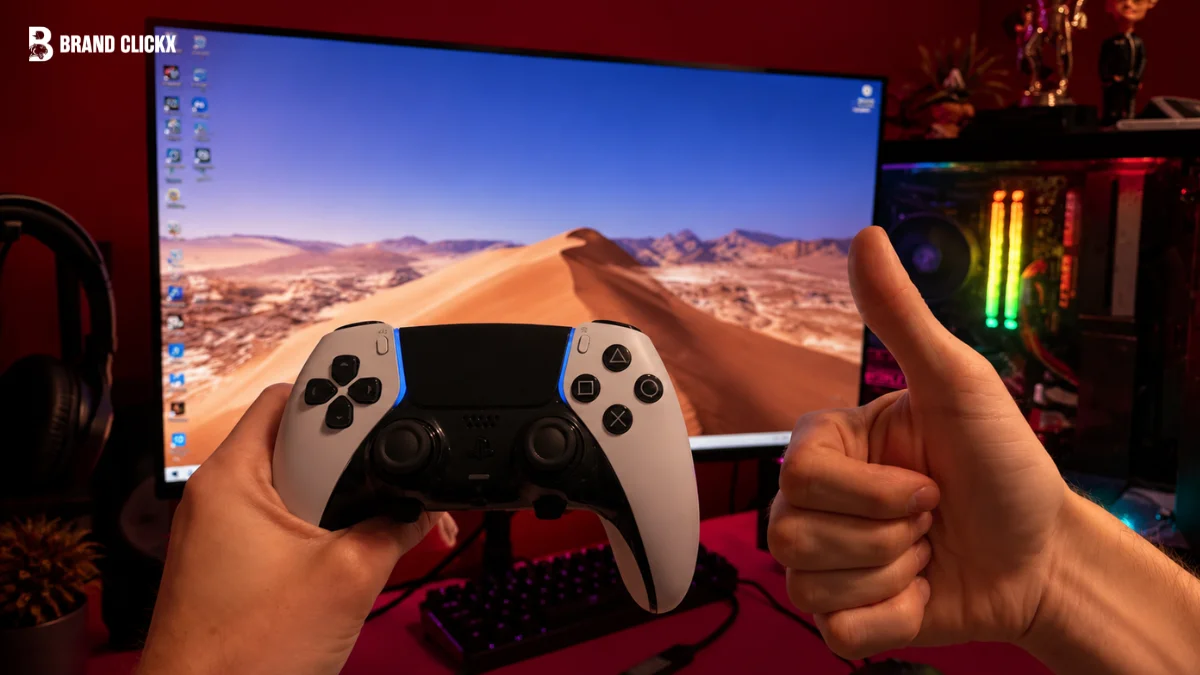 A PS5 controller and a gaming console displayed against a rich red studio backdrop.