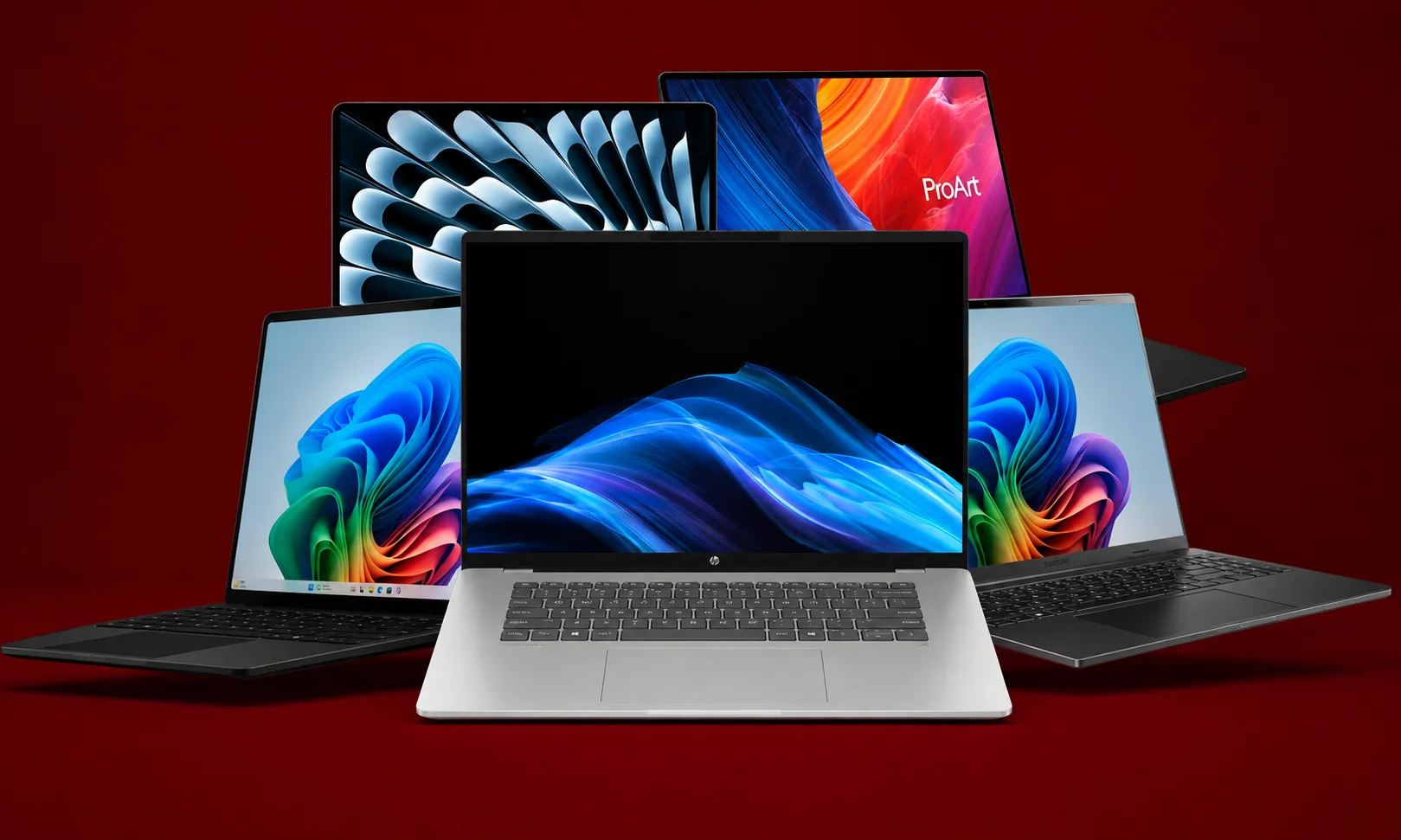 Multiple laptops arranged together displaying colorful high-resolution wallpapers.