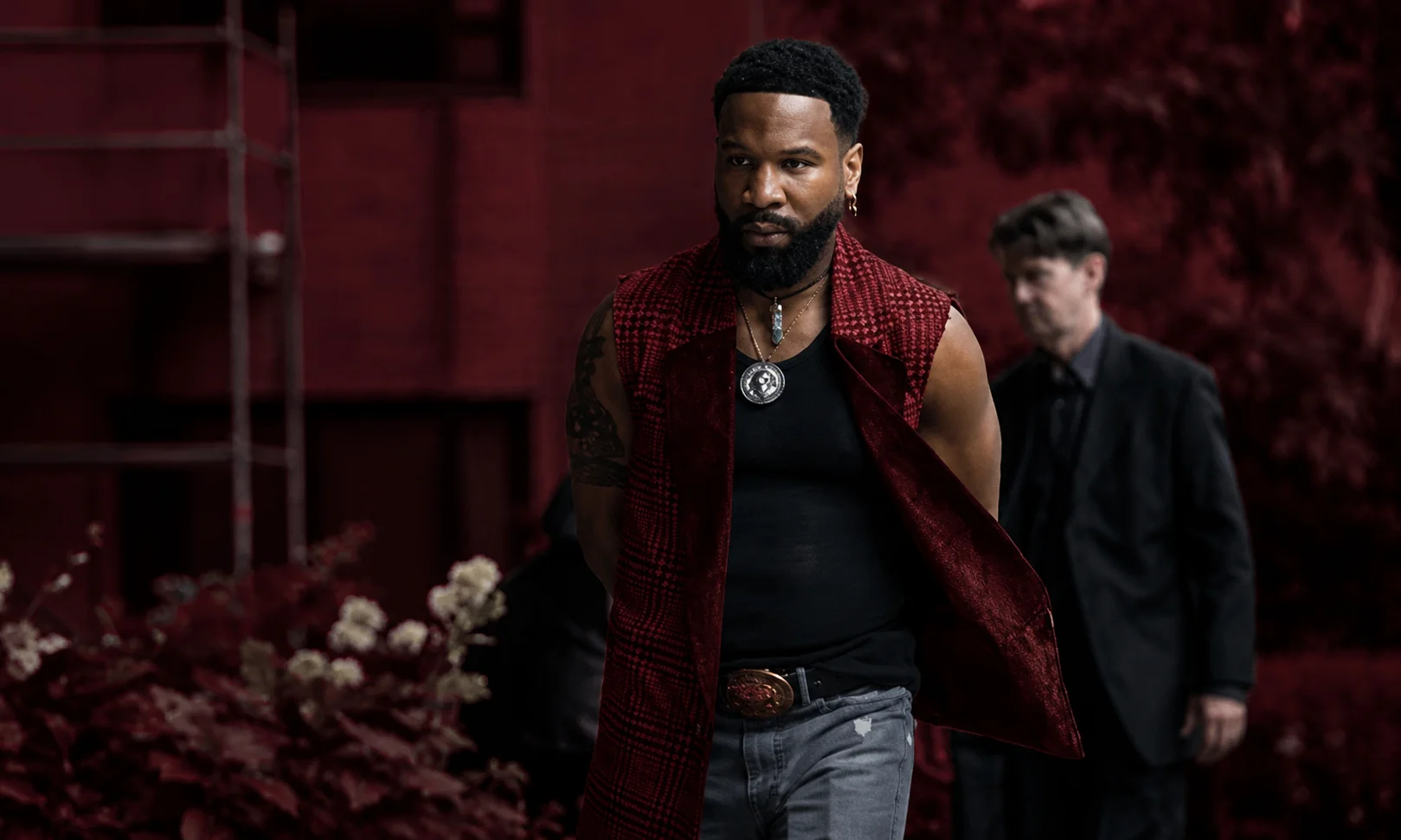 | Cast of Alex Cross TV Show: Full Season 3 Updates, New Actors & Release Date Portrait of Johnny Ray Gill as Bobby Trey Abellard set against a dark red ambient background.