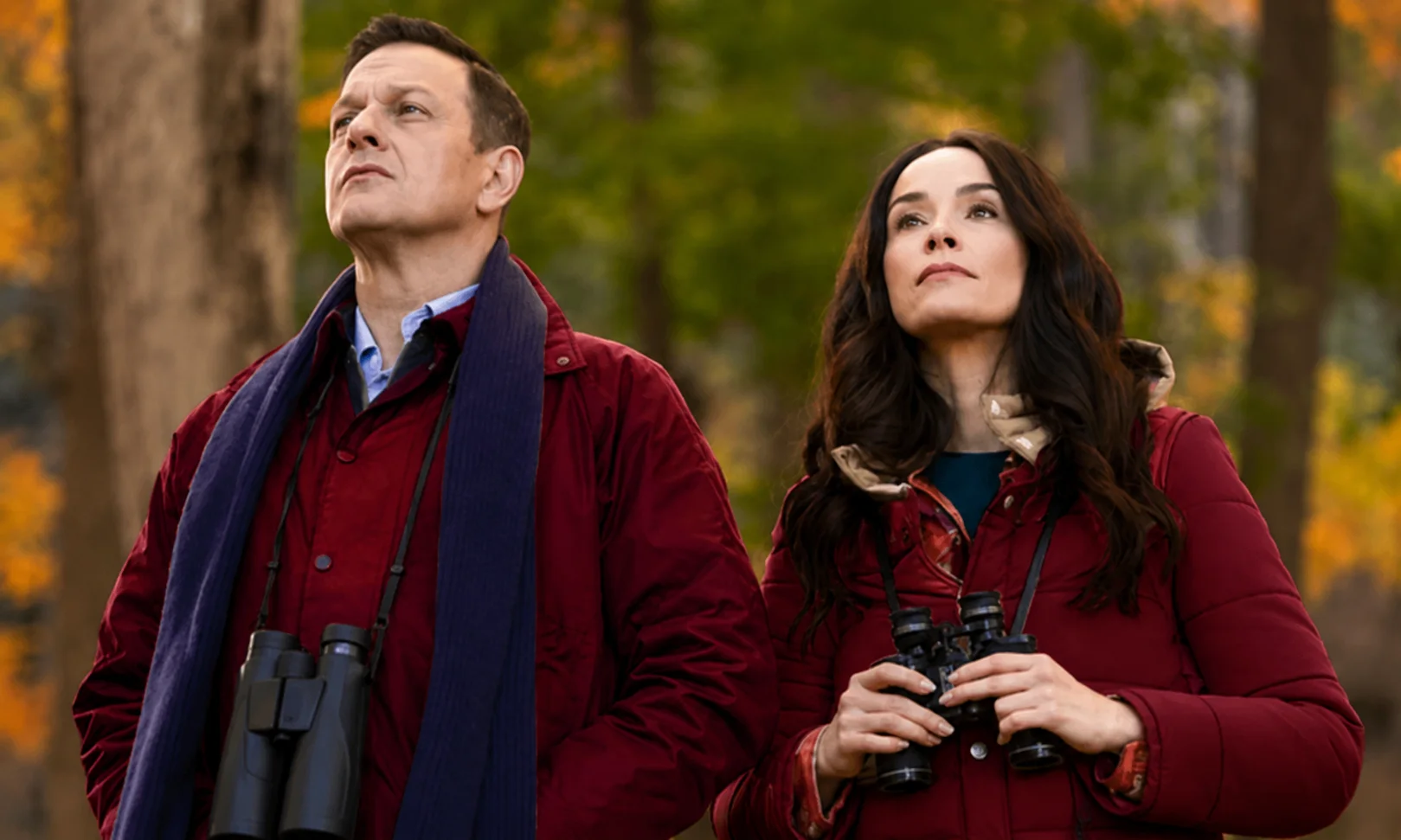 | Best Medicine: Everything to Know About the 2026 Medical Comedy Drama Dr. Martin Best and Louisa Gavin looking up outdoors while holding binoculars in a scene from Best Medicine