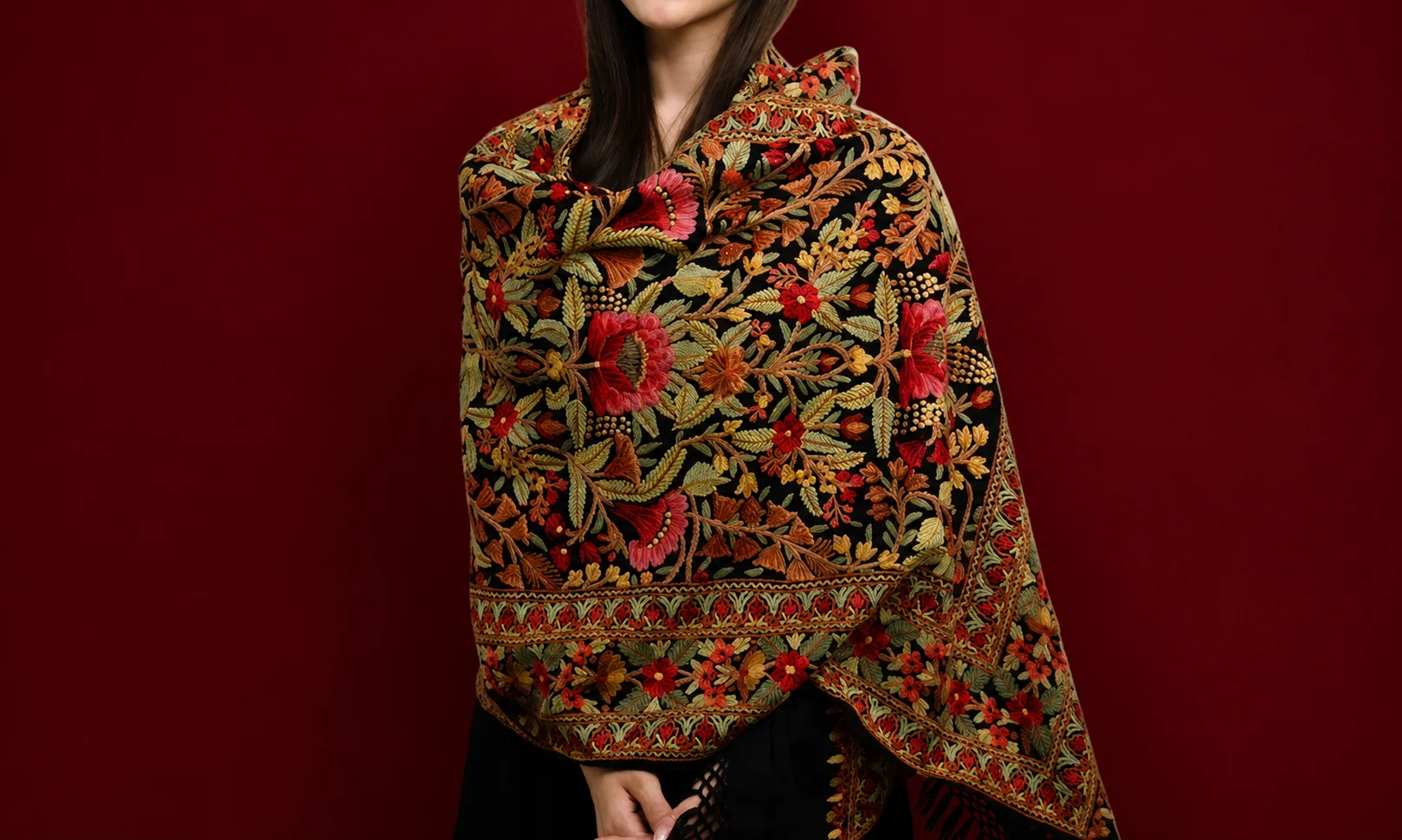 | Dupatta: Global Styling, History, Fabrics and Care Guide A person wearing a heavily embroidered traditional scarf featuring intricate floral patterns