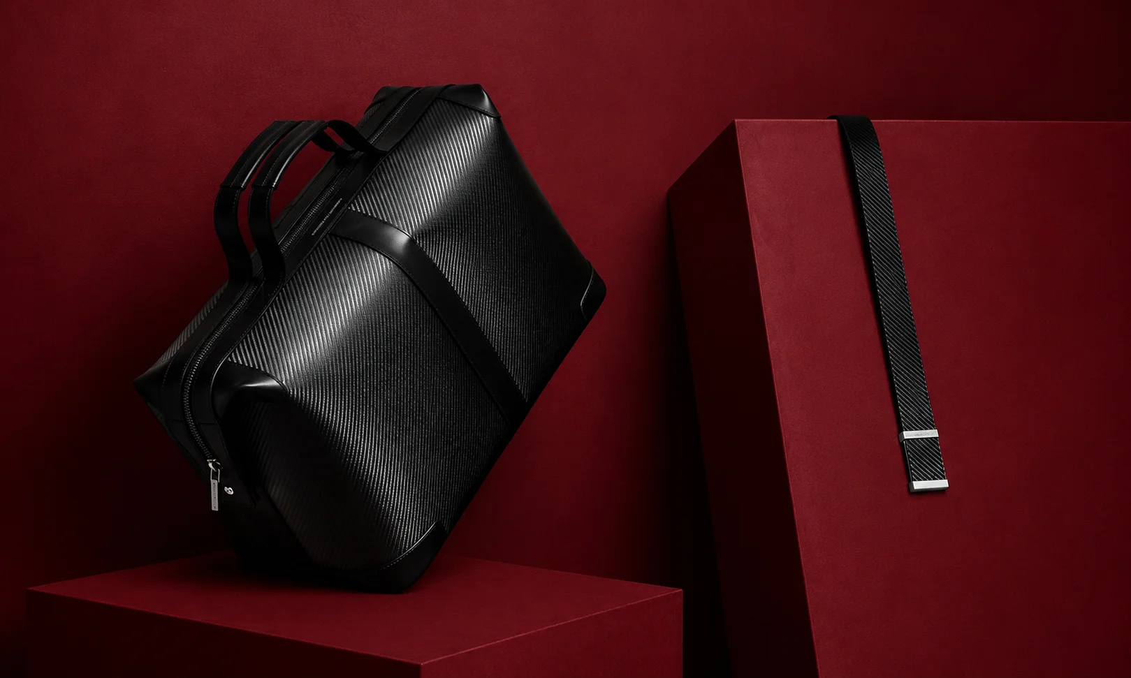 | 15 Best Luxury Luggage Brands for Travelers in 2026 Sleek black Porsche Design luggage pieces on a structured display.