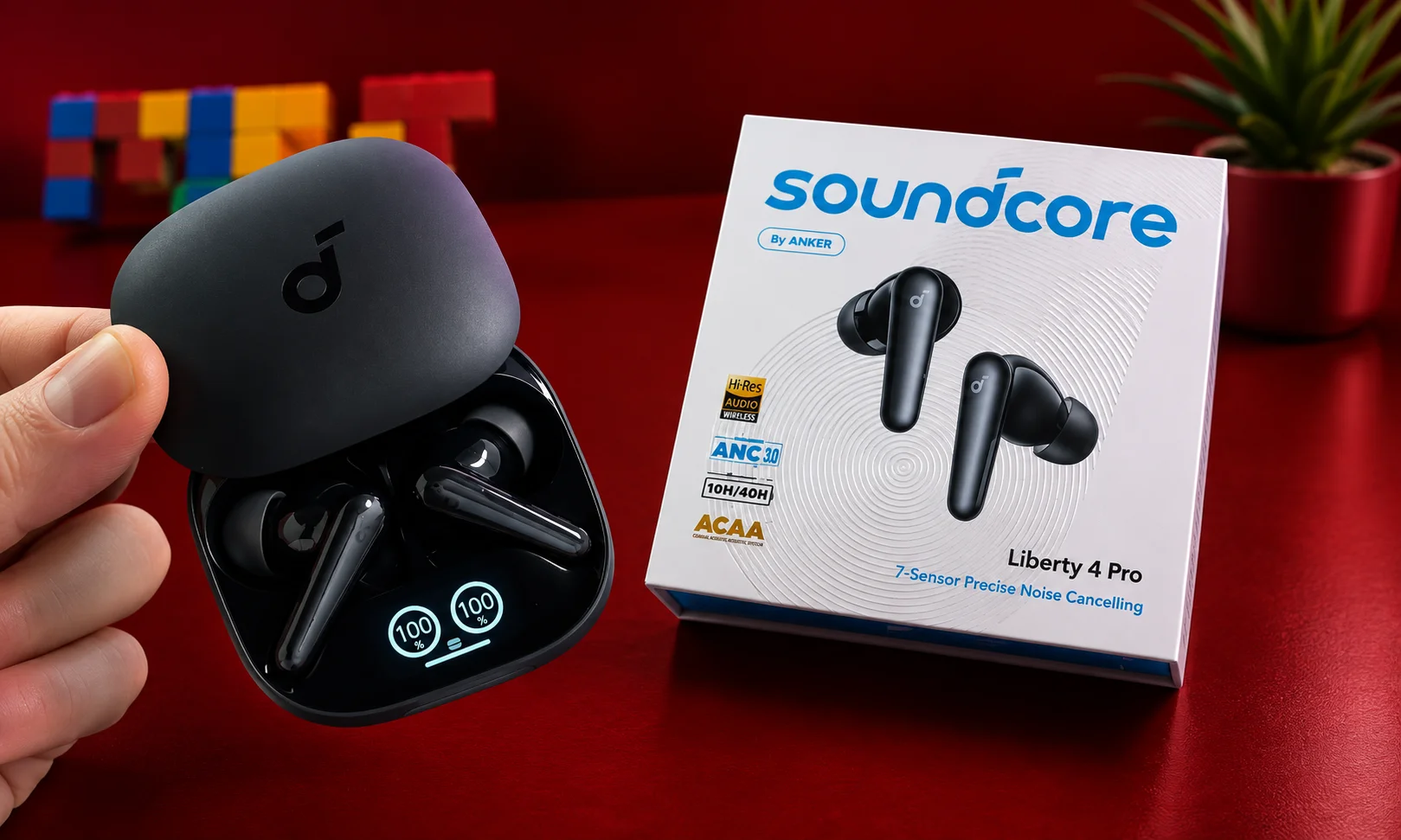 Soundcore earbuds shown next to their product packaging.