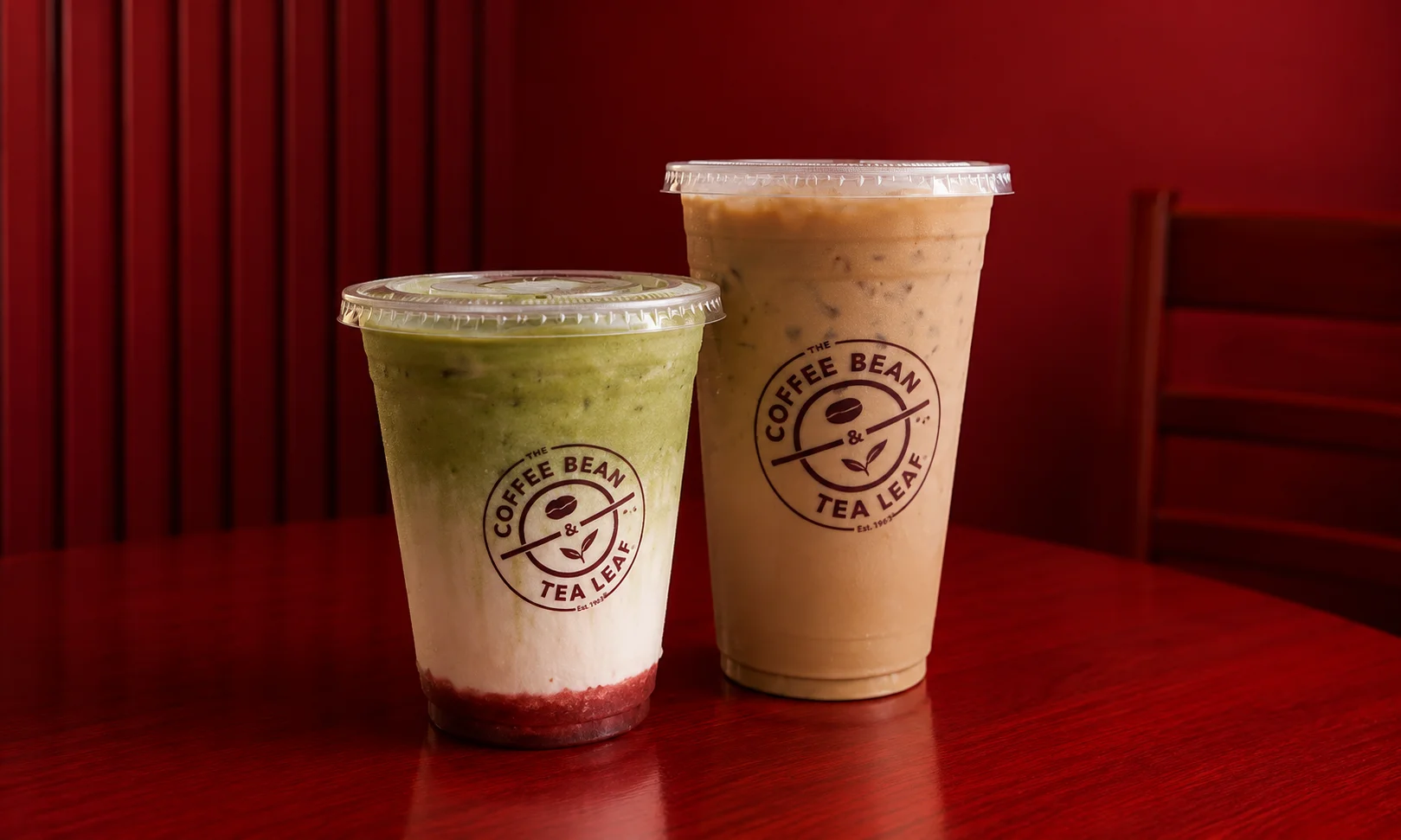 A warm, branded cup from The Coffee Bean & Tea Leaf on a counter.