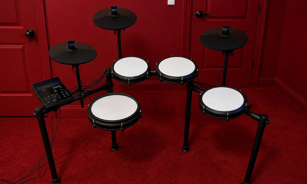 Complete electronic drum kit setup featuring mesh pads, cymbals, and a sound module on a red rug