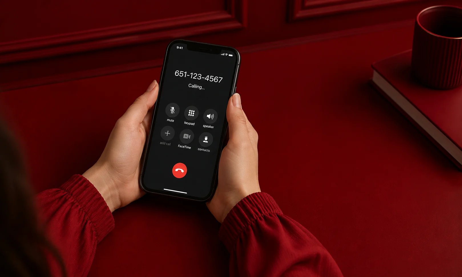Hands holding a smartphone showing an active incoming call with a 651 area code phone number on the screen.