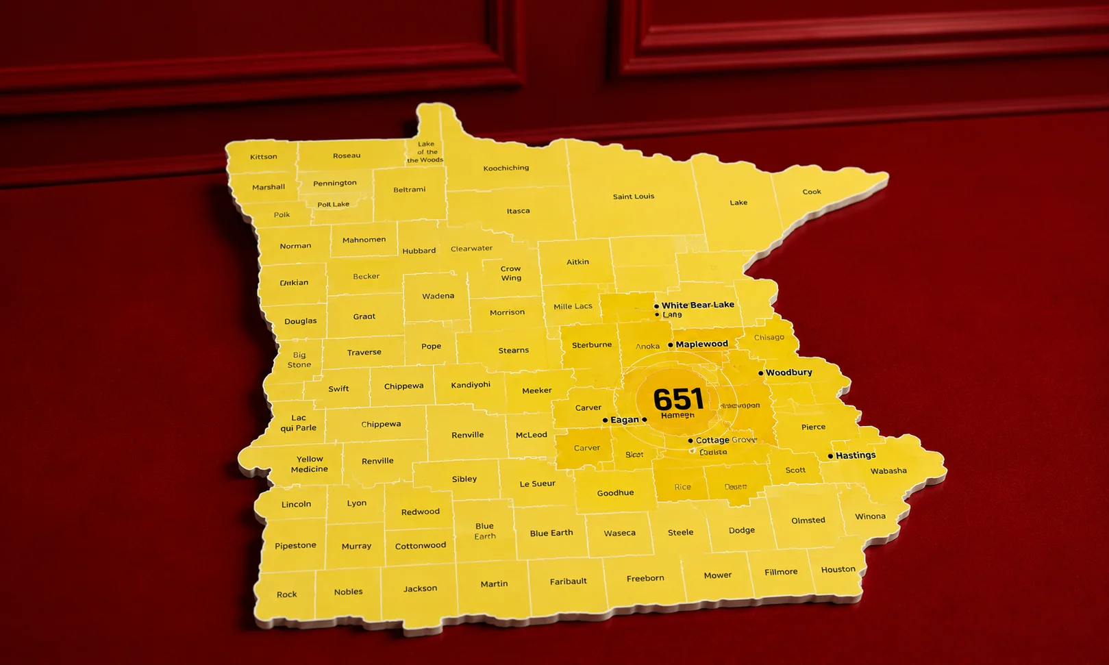 A yellow geographic map highlighting Minnesota counties and the 651 area code coverage zone for Saint Paul and nearby towns.