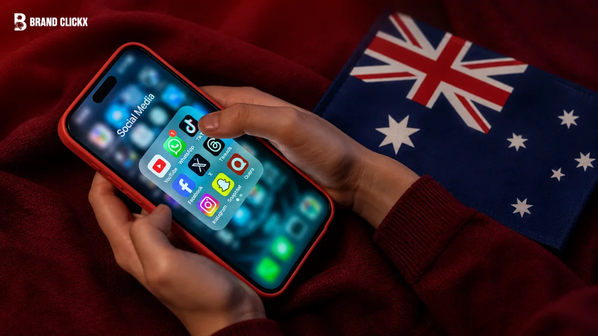 A person holding a smartphone showing social media apps next to an Australian flag representing the social media ban