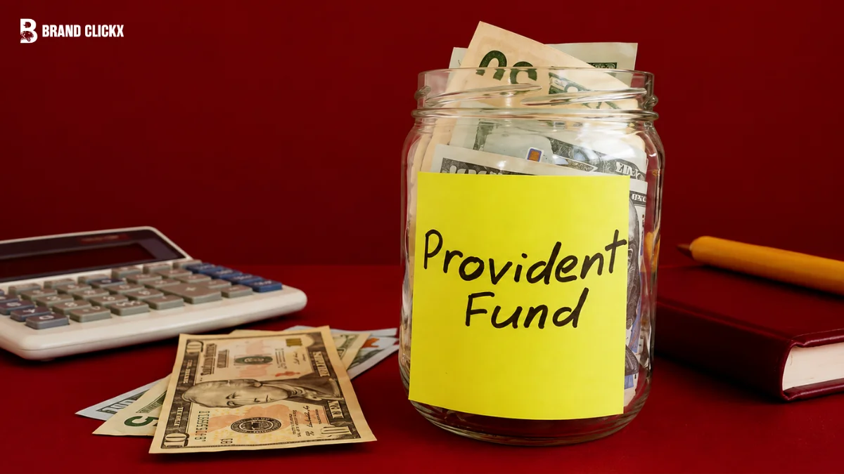 Piggy bank sitting beside stacked coins and a laptop representing employment provident fund savings.