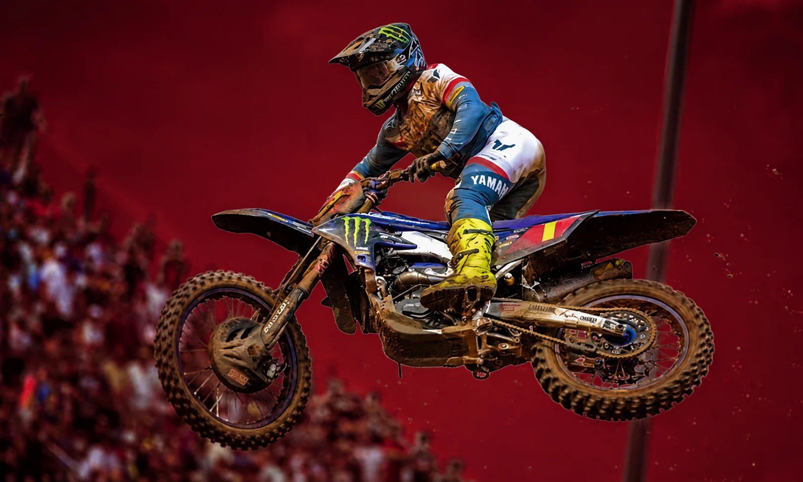 | Haiden Deegan: Career, Stats, 2026 News & Biography Portrait of Haiden Deegan posed with motocross gear set against a rich red studio backdrop.