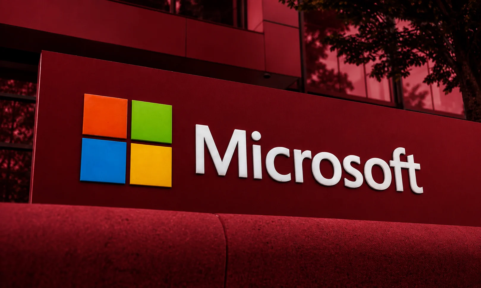 The Microsoft corporate logo displayed prominently against a deep red background.