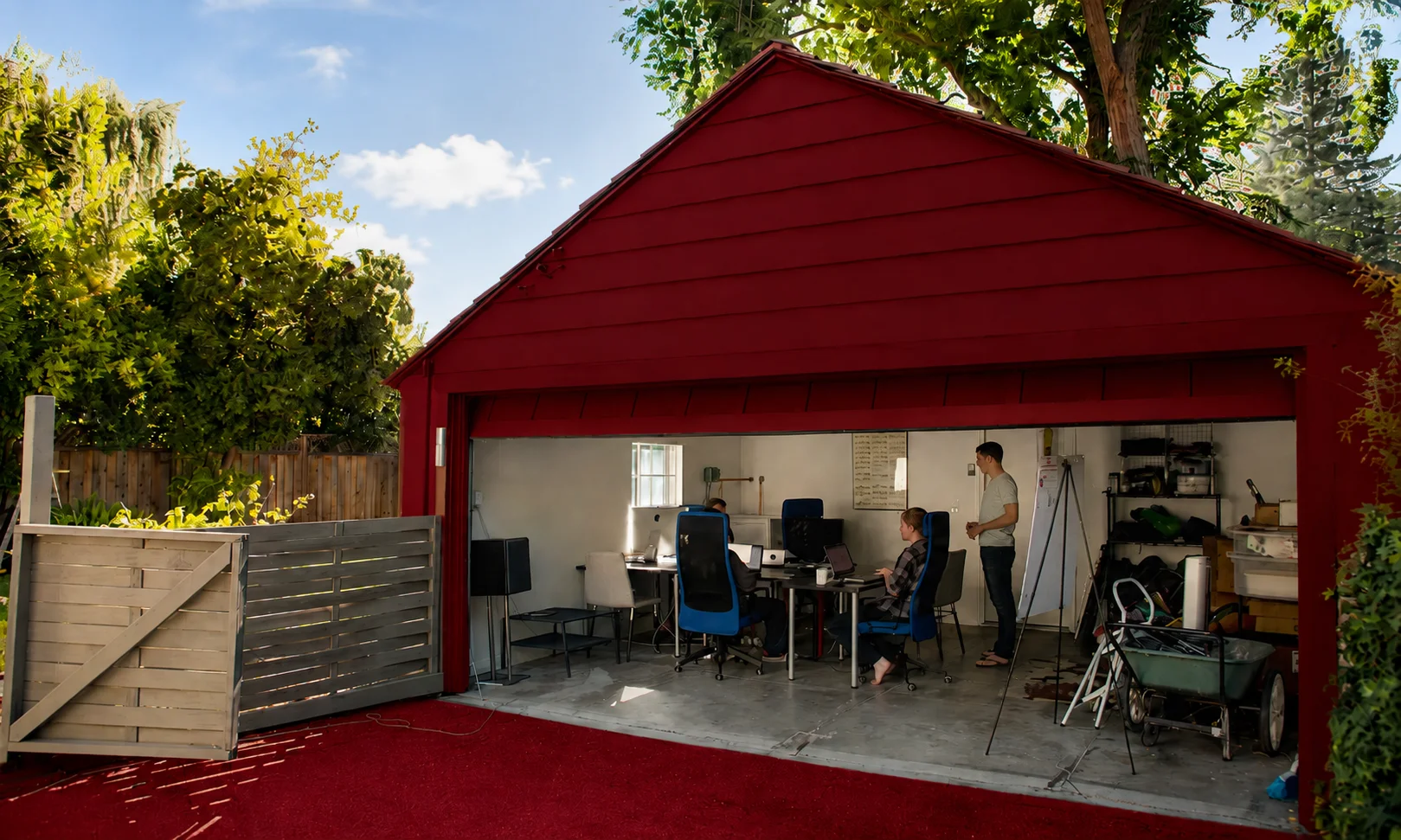 Exterior view of a garage workshop with ambient red lighting