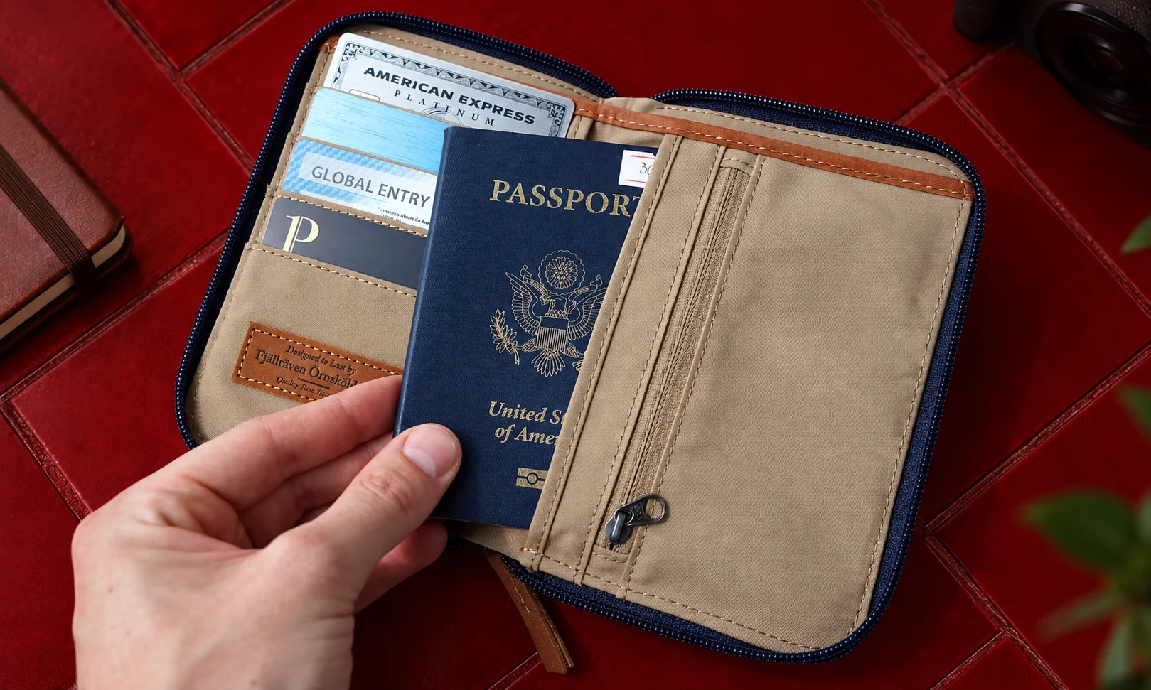 The Fj&auml;llr&auml;ven Passport Wallet opened to display card slots and a US passport holder for outdoor travelers.
