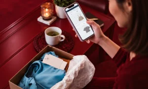Customer comparing ecommerce products on mobile alongside order box