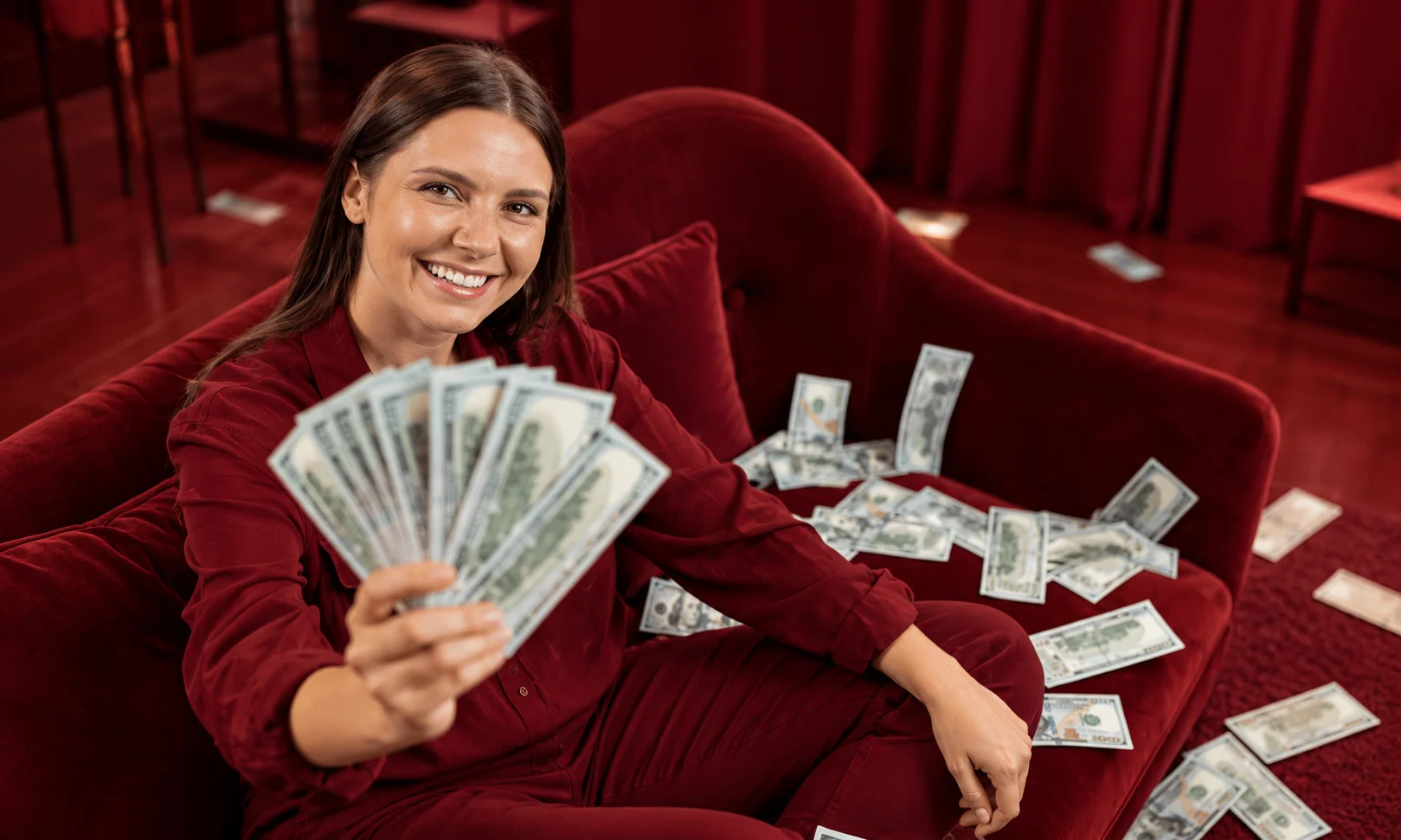 Female creator holding dollar bills representing monetization and paid media Creative Brief terms