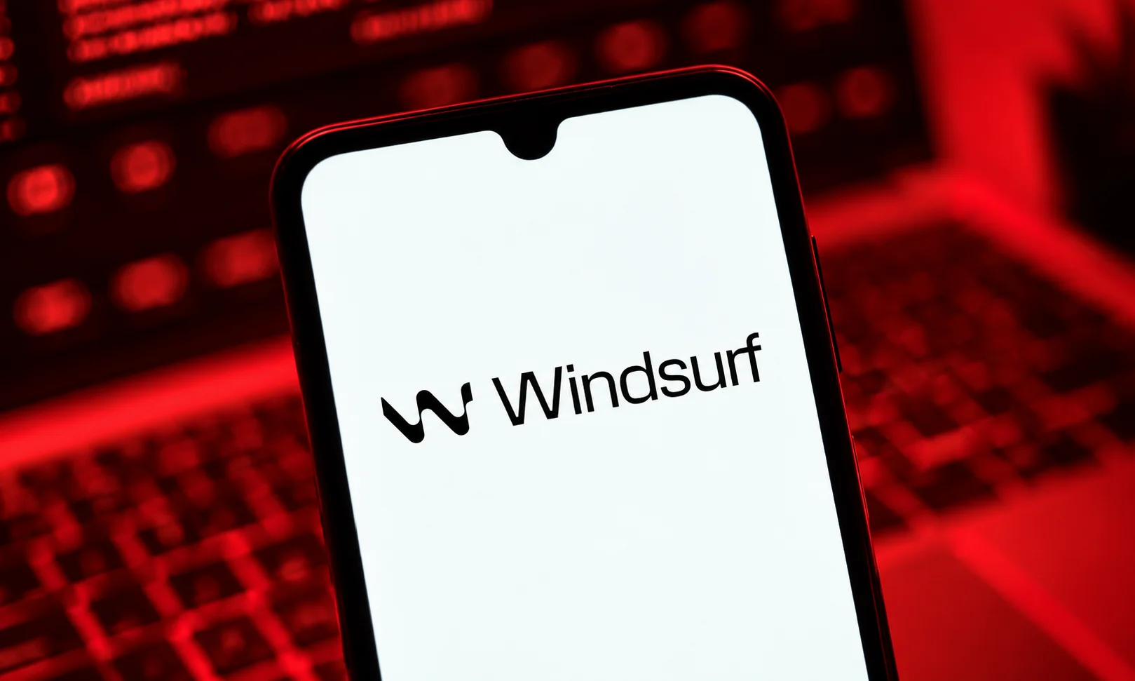 | Best AI Coding Tools for Developers in 2026 Smartphone displaying Windsurf logo for autonomous development workflows.