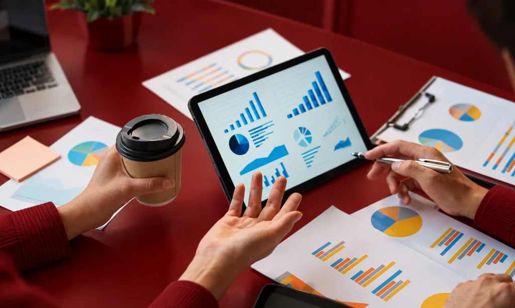 Market expansion strategy showing business growth charts and a team reviewing marketplace performance data.