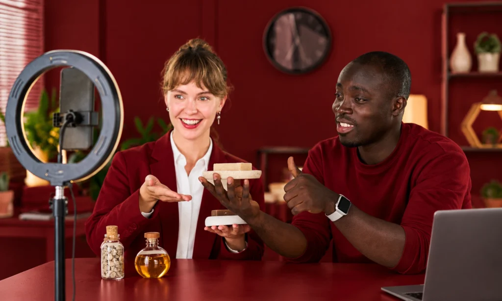 Content creators presenting products in front of a camera as part of a long-term creator partnership.