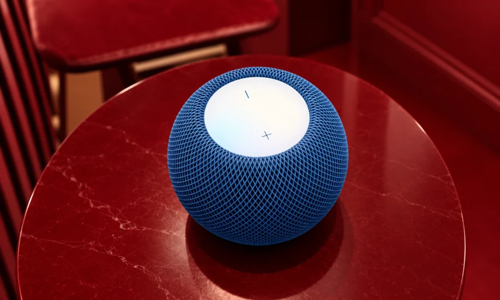 Blue Apple HomePod mini 2 smart speaker viewed from above, highlighting its mesh exterior and illuminated touch surface.